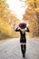 blonde woman poses on country lane in fall