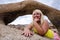 Blonde woman poses inside of Moibus Arch, also known as the Whitney Portal Arch, in the Alabama Hills area of California