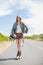 blonde woman posing while hitchhiking