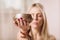 Blonde woman practicing yoga listens to the melody coming from the Tibetan bowl