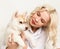 Blonde woman with puppy husky dog on a white sofa. girl playing with a dog