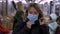 Blonde woman putting on protective mask in subway