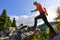 Blonde woman in red climbing boots walking on the mountains