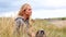 Blonde woman relaxing in the dunes