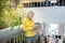 Blonde woman standing on stair landing, holding laptop, typing