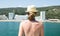 Blonde woman in a straw hat looks at the sandy Beach in Bulgarian resort