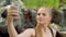 Blonde woman taking selfie in park. Trendy girl taking selfie photo on phone