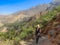 Blonde woman traveler walks along the Colca Canyon in Chivay, Peru, South America. Condors can be seen flying among the mountains