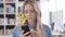 Blonde Woman Watching a Live Stream on Smartphone, Smileys, Emoji and Likes