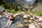 Blonde woman wearing a polka dot swimsut soaks and enjoys the Goldbug Hot Springs in the Salmon Challis National Forest of Idaho