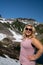 Blonde woman wearing sunglasses and smiling poses at Heather Meadows in Mt Baker, Washington State