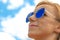 Blonde womans face with blue sunglasses