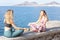 Blonde women meditate on the boardwalk