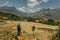 Blonde young girl hiking in Laotian mountains. Beautiful view of Laos landscape, spring valley, rice fields and Asian