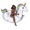 Blonde young Girl riding on an inflatable pool unicorn