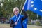 A blonde young man stands waving an EU flag at a Brexit protest in London