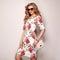 Blonde young woman in floral spring summer dress