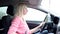 Blondie woman driving a car with manual gearbox