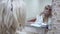 blondy woman brushing her teeth in the bathroom reflection mirror