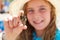 Blonk kid girl holding hermit crab