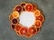 Blood juicy Sicilian orange slices on gray background in circle frame. Sliced blood orange texture. Citrus background