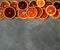 Blood juicy Sicilian orange slices on gray background. Sliced blood orange texture. Citrus background. Copy space