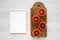 Blood oranges halved on rustic wooden board, blank notepad over white wooden background, top view. Flat lay, overhead, from above