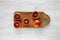 Blood oranges halved on rustic wooden board over white wooden background, top view. Flat lay, overhead, from above. Close-up