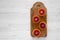 Blood oranges halved on rustic wooden board over white wooden surface, top view. Flat lay, overhead, from above