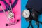 Blood pressure gauge or sphygmomanometer and medical stethoscope in two colors background: blue and pink. Concept of preparation o