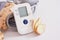 blood pressure monitor and ginger root on gray background