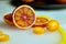 Blood or red orange and kumquat on cutting board  halves and slices of citrus fruits