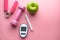 blood sugar measurement for diabetes with apple and dumbbell