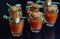 Bloody Mary cocktails in the shots drink served with Halloween bloody fingers, pork cocktail sausages decorated with flaked