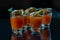 Bloody Mary cocktails in the shots drink served with Halloween bloody fingers, pork cocktail sausages decorated with flaked