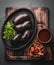 Bloody sausages - chilean preta on iron plate, top view, grey slate background