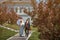 blooming apple trees with pink leaves and dark red flowers. wedding in luxurious garden. the bride and groom in vintage images