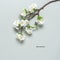 Blooming cherry branch artificial on a gray background. Creative layout. Spring tender background. Top view, flat lay