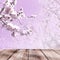 Blooming cherry branch with empty wooden table background.