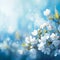 Blooming elegance Spring branch with white flowers on blue bokeh