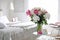 Blooming peonies on table in bedroom. Space for text