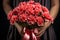 Blooms for her Woman\\\'s hands clasp carnation bunch, a Mother\\\'s Day sentiment