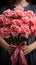 Blooms for her Woman\\\'s hands clasp carnation bunch, a Mother\\\'s Day sentiment