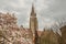 Blossom tree in background Our Lady Church - Brugge, Belgium.