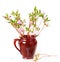 The blossoming Labrador tea branches with pink colors in a ceramic pot