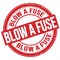 BLOW A FUSE text written on red round stamp sign