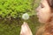 Blowing on a dandelion