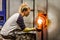 Blowing Glass Professional Woman Working on a Vase.