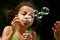 Blowing soap bubbles