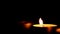 Blown out candles on dark low key background, thirty frame per second, pan shot